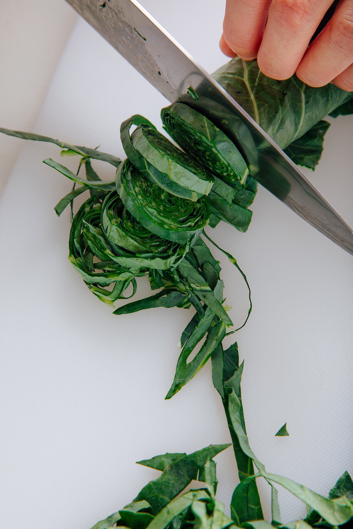 thinly slicing collard greens