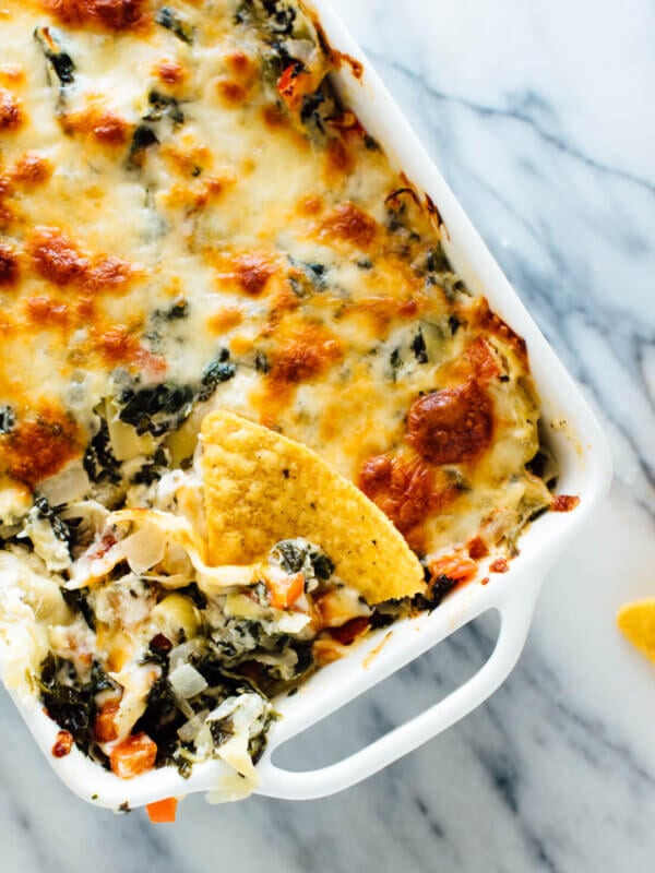 The best cheesy spinach artichoke dip, made lighter with extra veggies and no mayonnaise! Everyone will love this appetizer recipe.