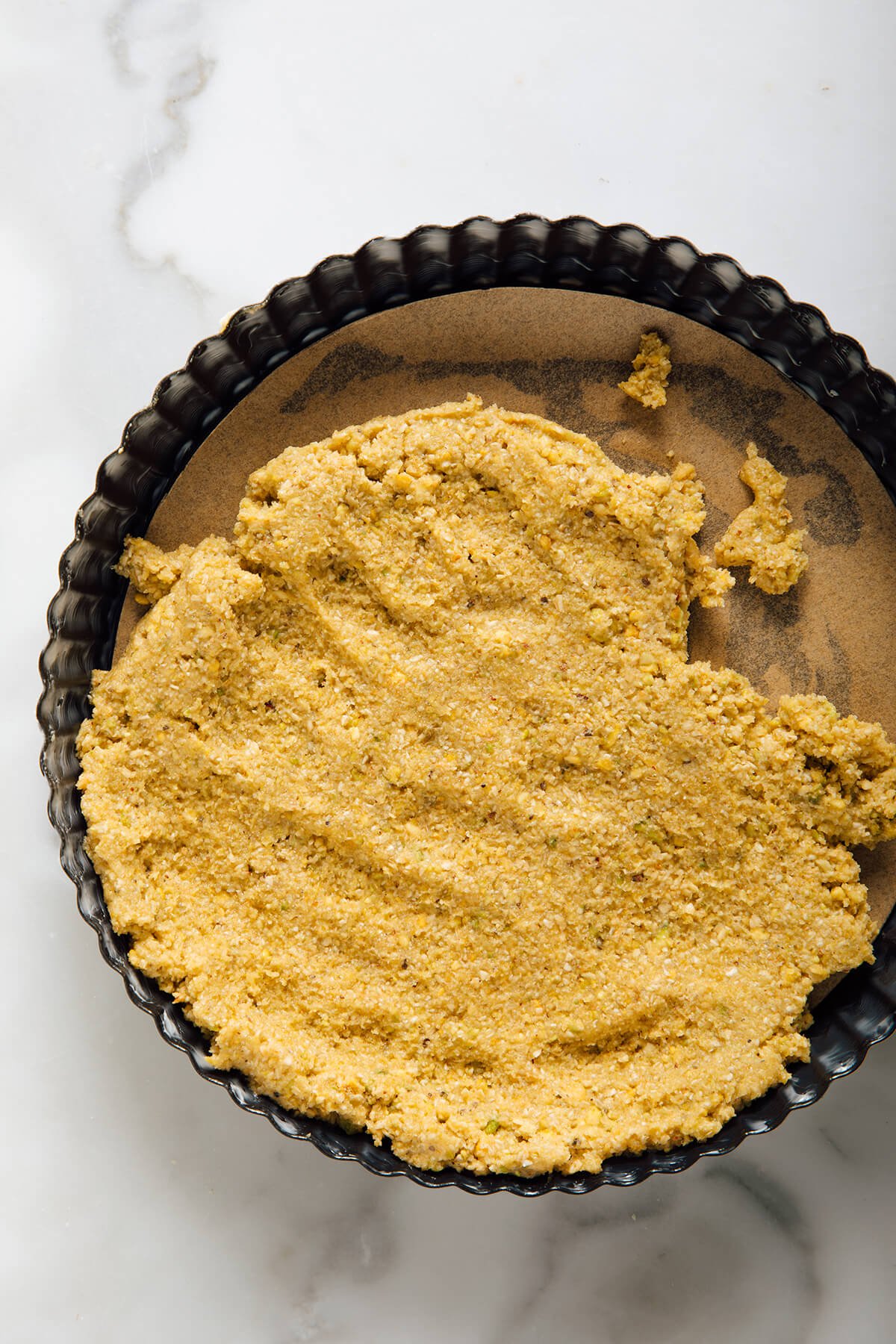 pressing crust into tart pan