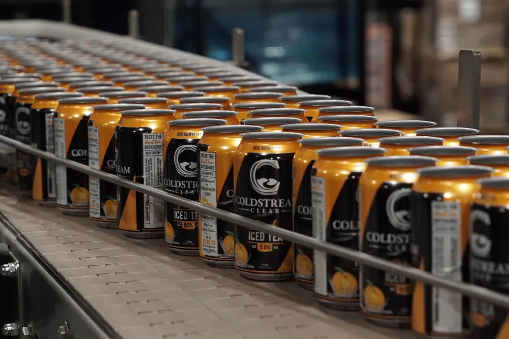 Cans of Coldstream Clear lined up at a canning facility