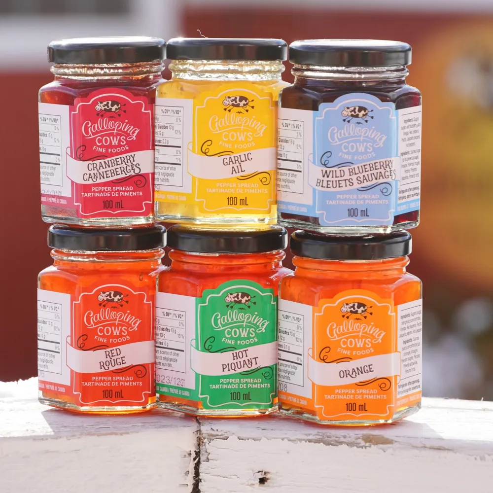 Six flavours of Galloping Cows Preserves in jam jars