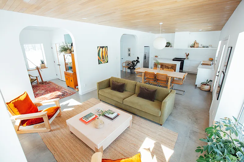 A brightly lit room with colourful furniture