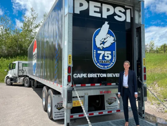 Owner of Cape Breton Beverages next to Pepsi truck