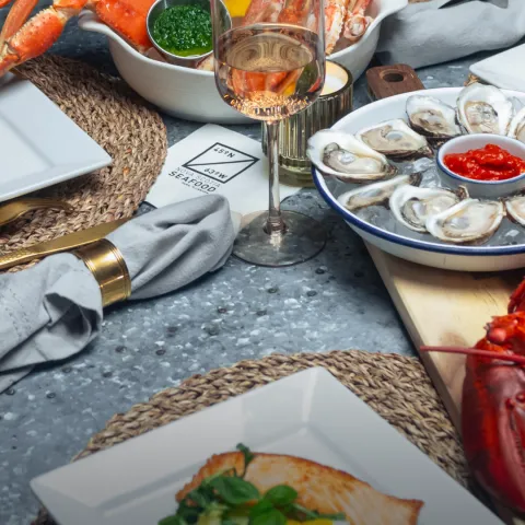 Nova Scotia Seafood - Lobster, Crab, Oysters, Salmon plated on a table