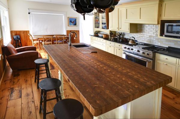 A Larch Wood kitchen island countertop with three stools