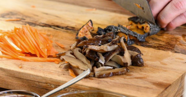 Person cutting up sea cumber on a cutting board