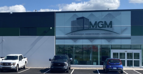 Front of a two story commercial building with parked cars in front