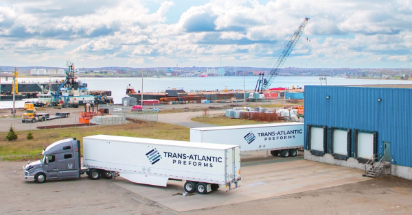 Transport trucks outside of manufacturing facility
