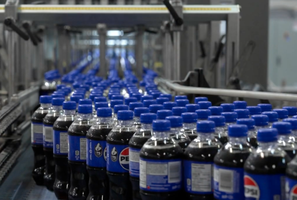 Pepsi in bottles on an assembly line