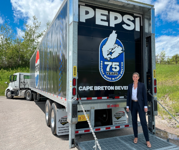 Owner of Cape Breton Beverages next to Pepsi truck