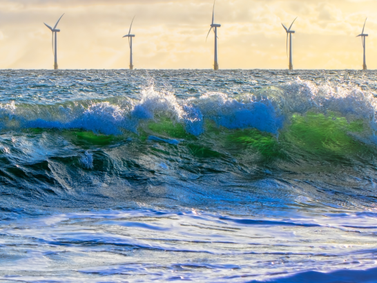 Ocean waves and wind farm image for Marine Renewables Article