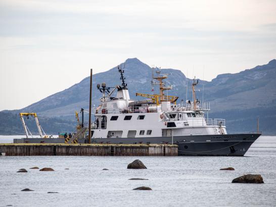 A sea vessel with lots of visible instrumentation and a grey hull bearing the name LEEWAY ODYSSEY is docked at a jetty.