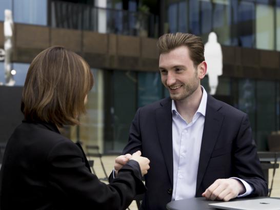 picture of ImmigrateAI Global founder, Max Medyk shaking hands