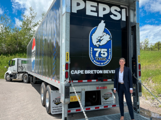Owner of Cape Breton Beverages next to Pepsi truck